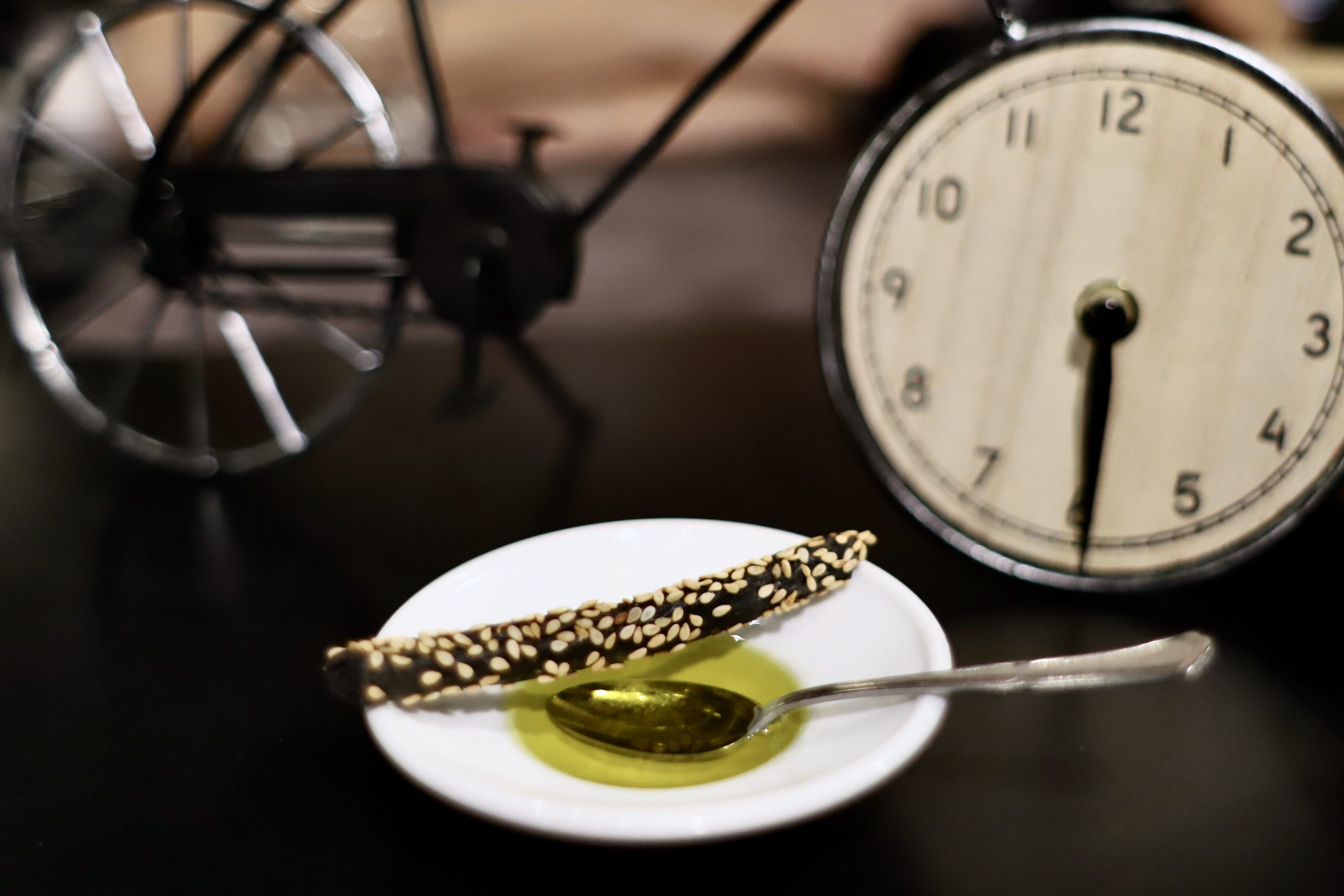 A perfect appetizer setup: black grissini (Italian breadsticks) with sesame seed and olive oil