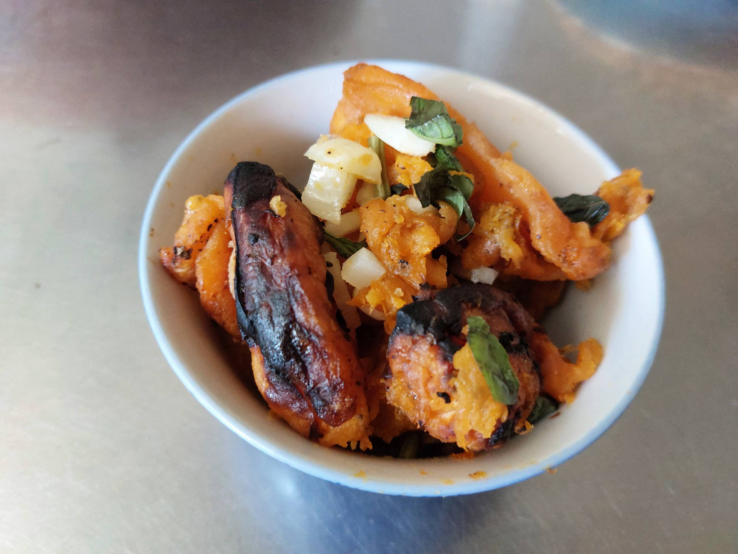 Roasted sweet potato served with garlic and basil