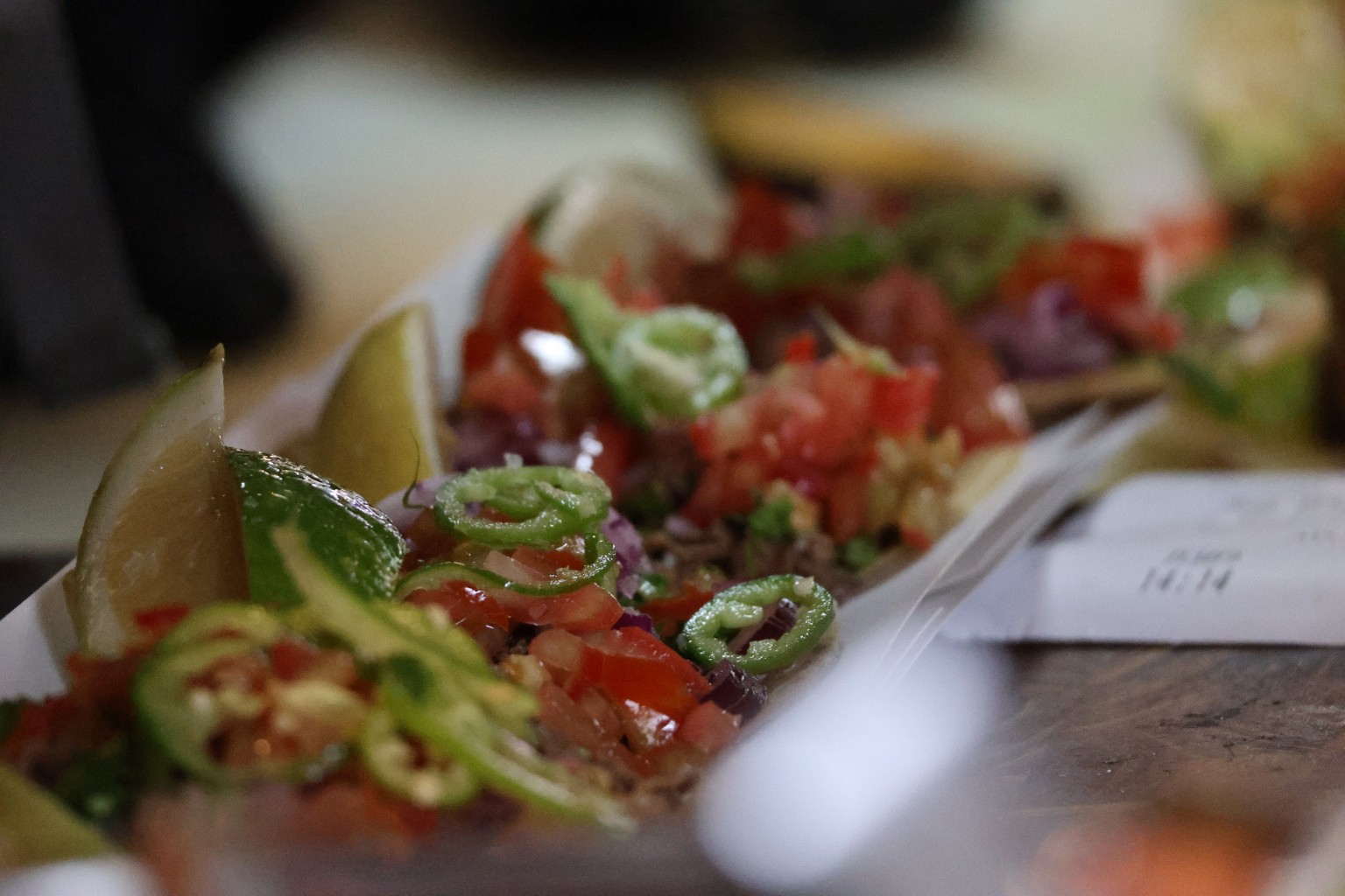 Fresh tacos layered with avocado, lime, tomato and chili