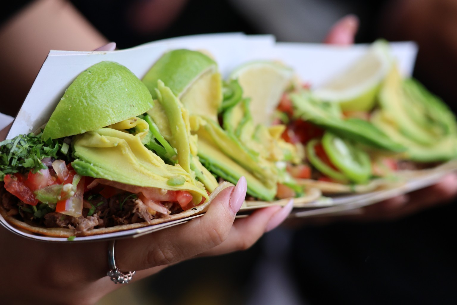 Fresh tacos layered with avocado, lime, tomato and chili