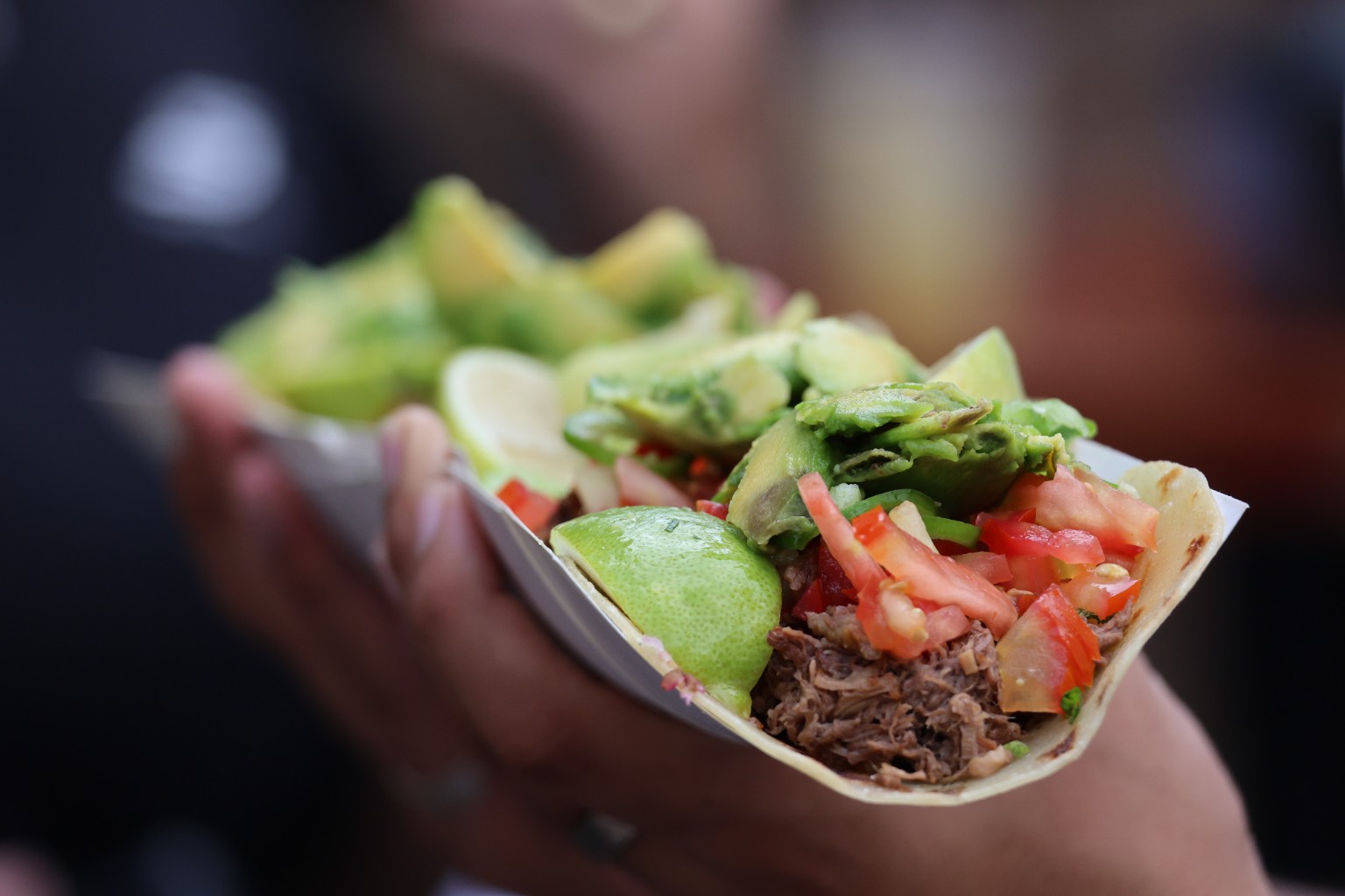 Fresh tacos layered with avocado, lime, tomato and chili