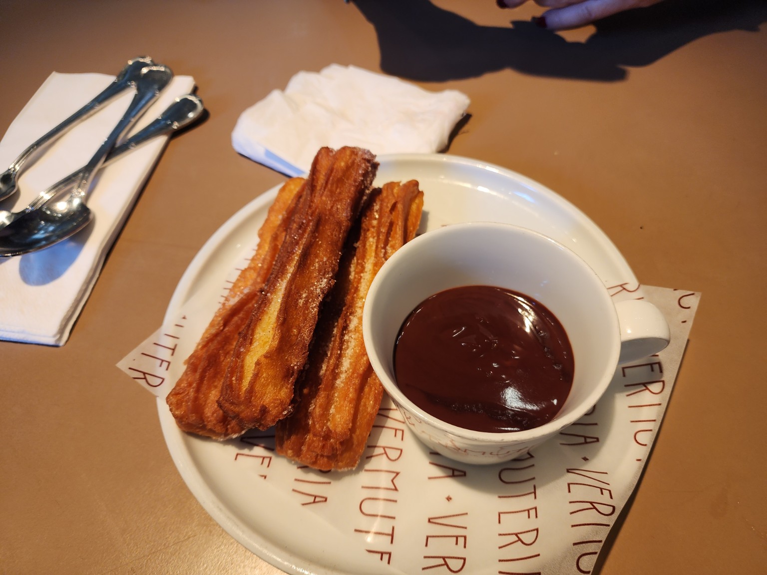 Golden churros with thick dark chocolate